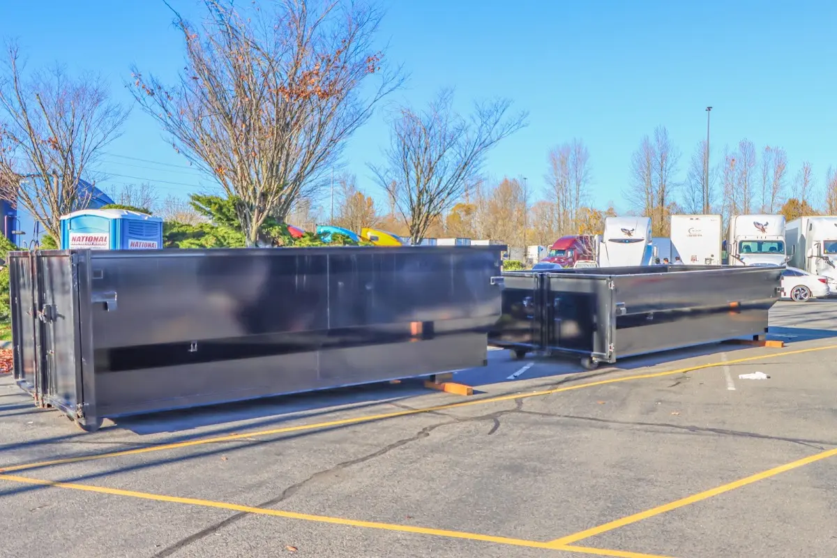 Professional dumpster rental service with roll-off container on residential driveway in Terre Haute